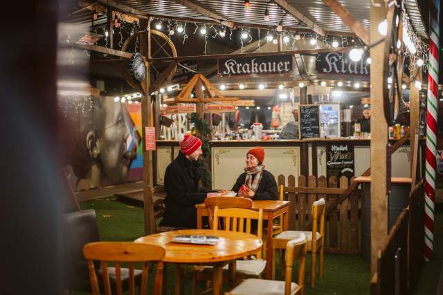 young couple enjoying a drink in a german themed bar at swansea christmas market