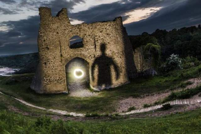 Creepy silouhette against castle at night time