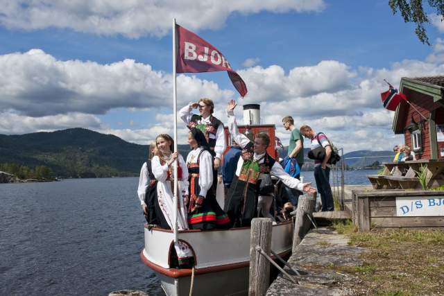 People wearing national costumes on board the old steam boad Bjoren. Photo