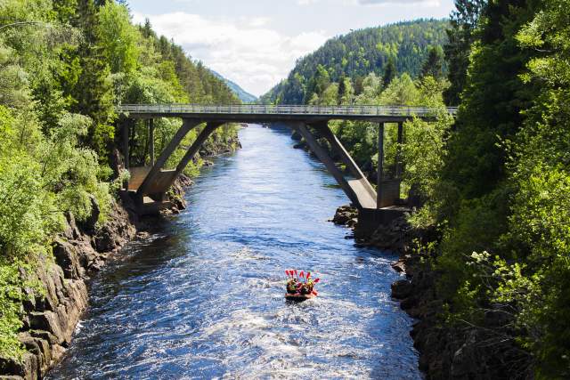 rafting boat under a bridge