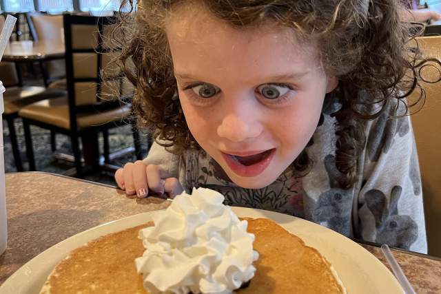 Little girl staring at pancake at Capitol Pancake House