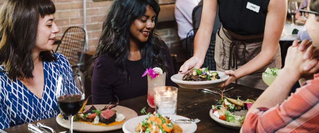 A group of friends enjoying a meal at a Downtown Salt Lake City Restaurant