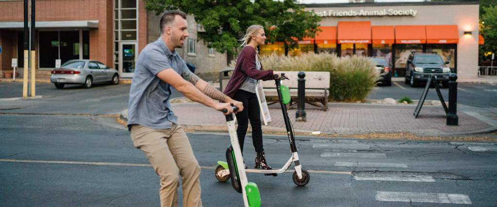 Couple riding Lime Scooters in Sugar House
