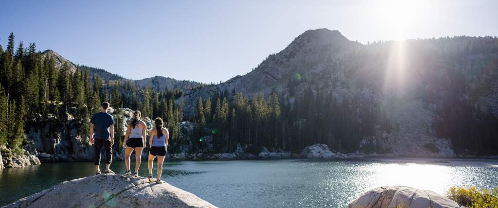 Friends hiking to a lake in Big Cottonwood Canyon