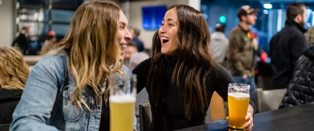 LGBTQ couple drinking at Fisher Brewing