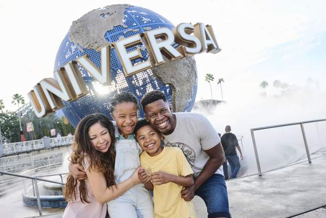 A family posing in front of the Universal Orlando Resort globe
