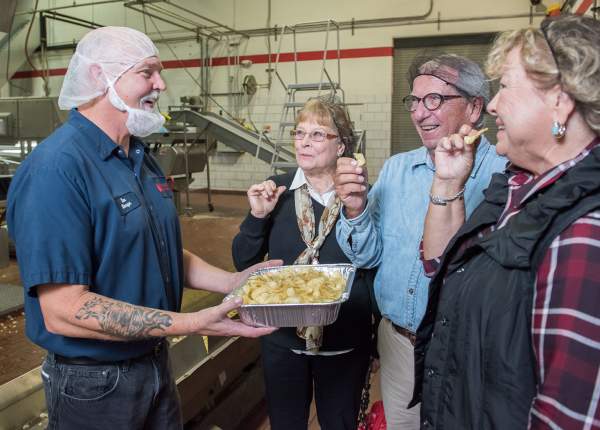 People tasting Martin's potato chips fresh out of the fryer