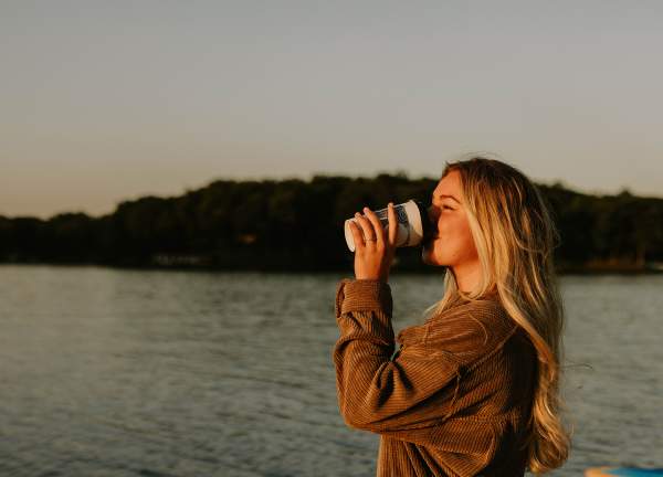 Girl drinking coffee at Lake Sara
