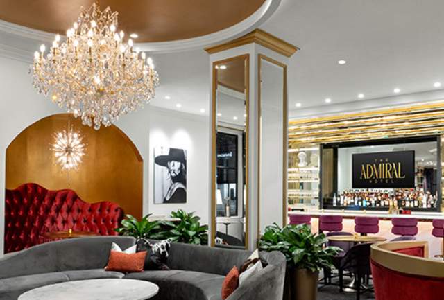 Ornate room with sectional seating and a bar