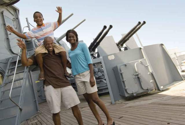 family standing on the deck of the USS Alabama Battleship