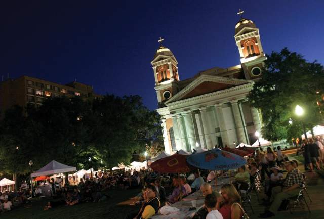 An art festival at night in front of a cathedral