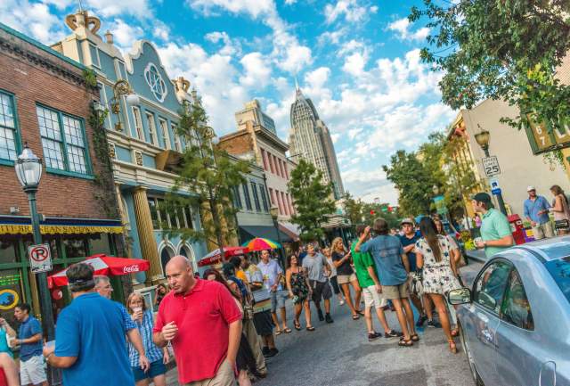 group of people walking in the street downtown Mobile