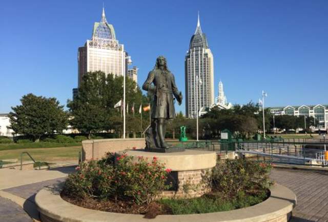 statue in front of high rise buildings