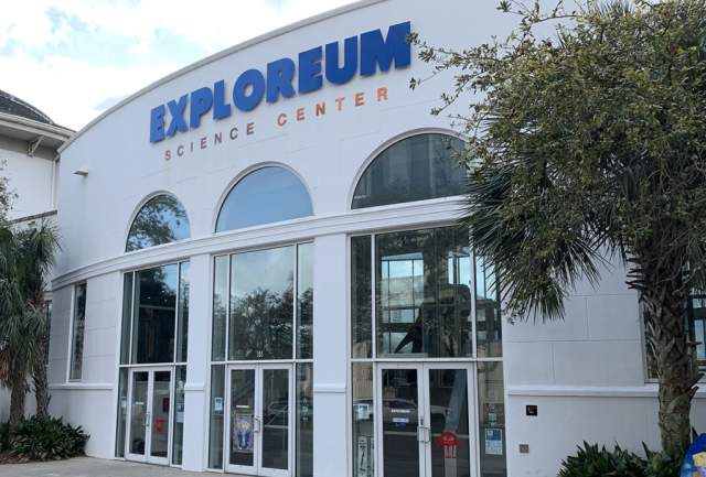 two-story building with three arched doorways