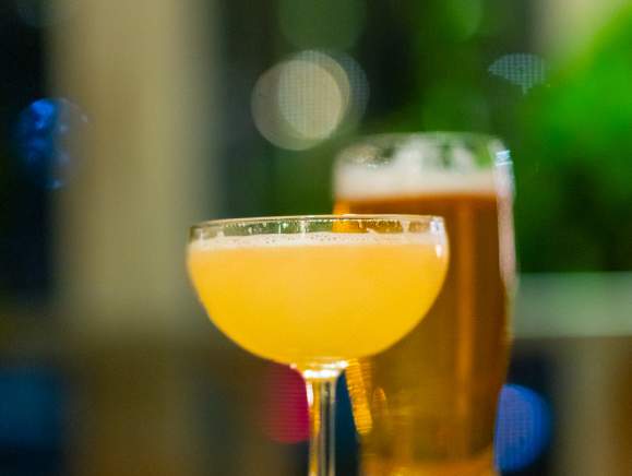 two beverages with green lights behind