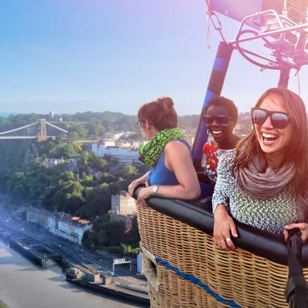 A group of people in a balloon basket flying near the Clifton Suspension Bridge in West Bristol - credit Paul Box