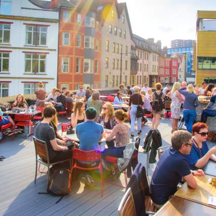 People sitting under the sun on the roof terrace at the Bambalan restaurant, central Bristol - credit Bambalan