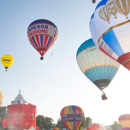 A group of balloons lifting off in a mass ascent at Bristol International Balloon Fiesta - credit Paul Box