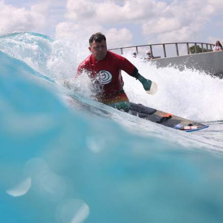 A surfer taking part in adaptive surfing at The Wave inland surfing lake near Bristol - credit The Wave