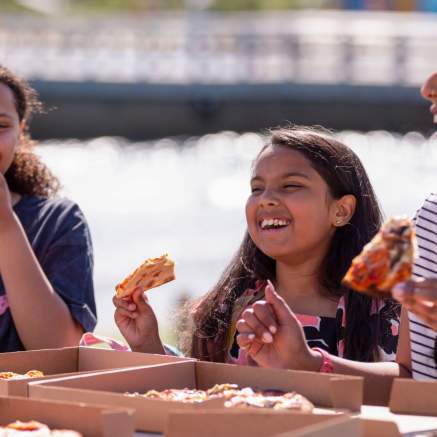 A family eating pizza at The Wave inland surfing lake near Bristol - credit The Wave