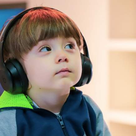 A young boy wearing headphones at the We The Curious science centre in Bristol - credit We The Curious