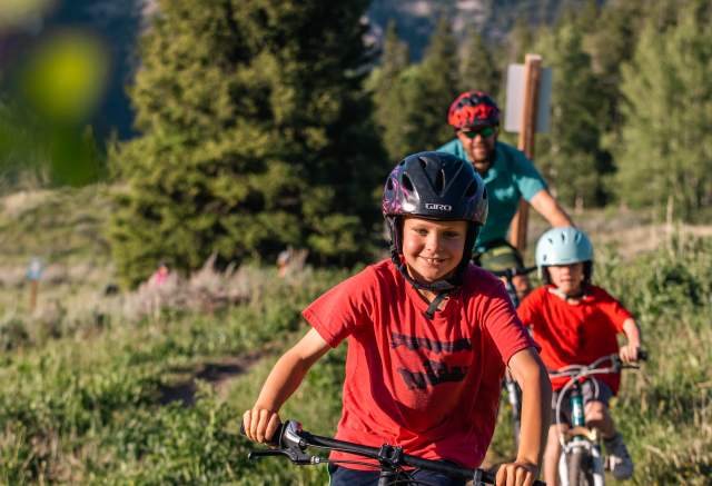 Kids riding bikes on a trail