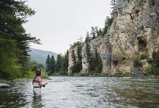 Woman fly-fishing in Big Sky