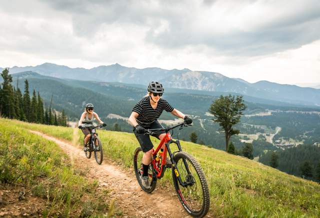 Two girls mountain biking