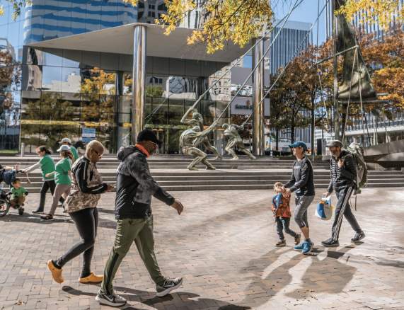 People walking by the Bank Of America Financial Center