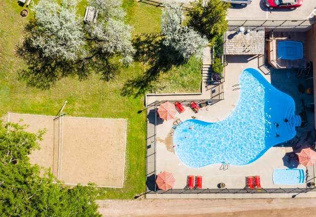 drone shot over the pool and sand volleyball court at the Rapid City KOA