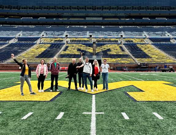 Tour group standing on field of Michigan Stadium