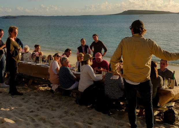 IOS Nav Landscape Large - F&D -  Taste of Scilly - Simon Stallard in front of table Tresco 1750 x748
