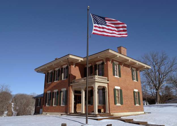Brick home of Ulysses S. Grant, with an American flag flying in the front, during winter.
