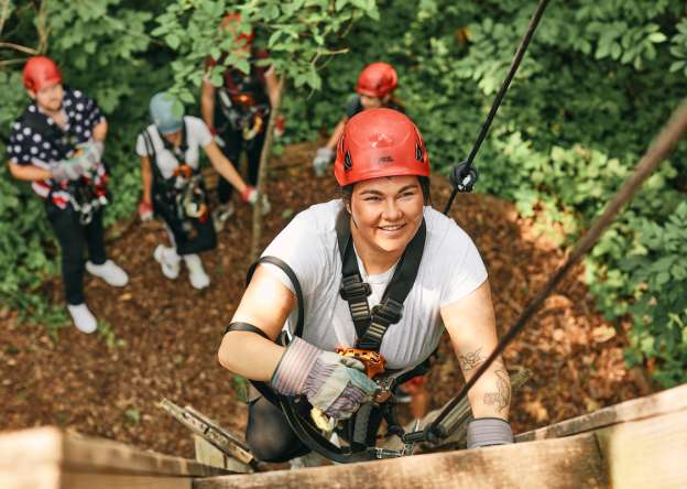 Woman on high ropes course
