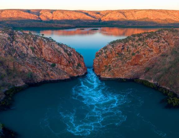 A drone image showing water flowing through the wide gap of Garaanngaddim Horizontal Falls on the Kimberley Coast