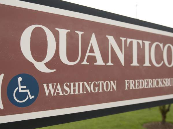 A sign that says "Quantico" with arrows pointing towards Washington and Fredericksburg