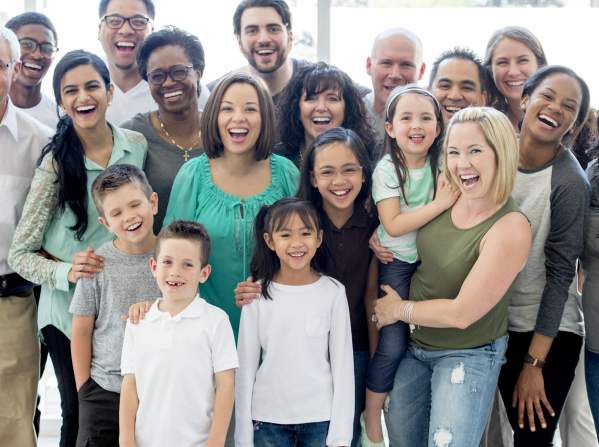 A diverse group of people standing together and smiling