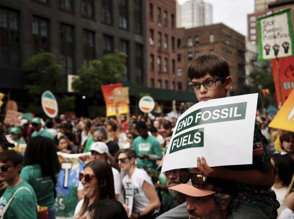 Tens of thousands march to kick off climate summit, demanding end to warming-causing fossil fuels