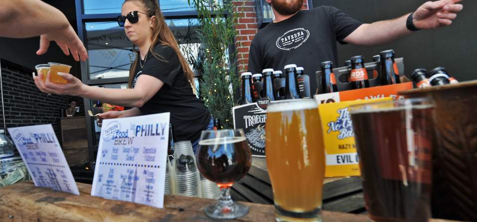 Bartenders serving beer at the Downtown Newark Food + Brew Festival