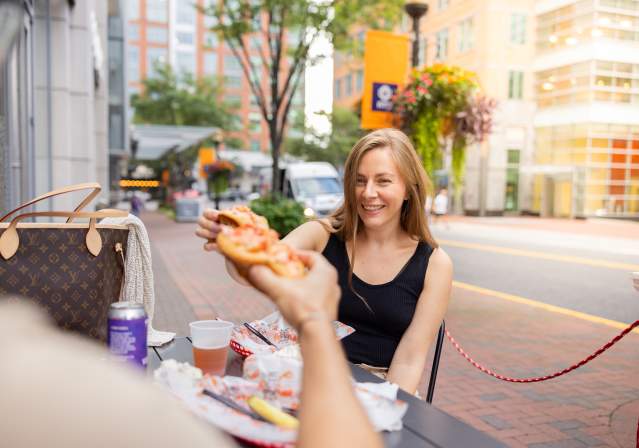 Woman toasting with lobster rolls.