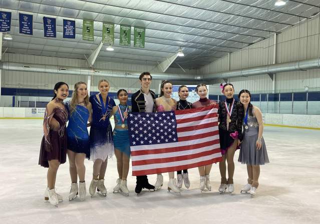 Skaters Holding an American Flag at the Solo Ice Dance Competition