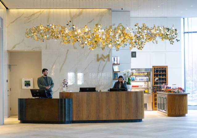 Two People Working as Receptionist at the Front Desk
