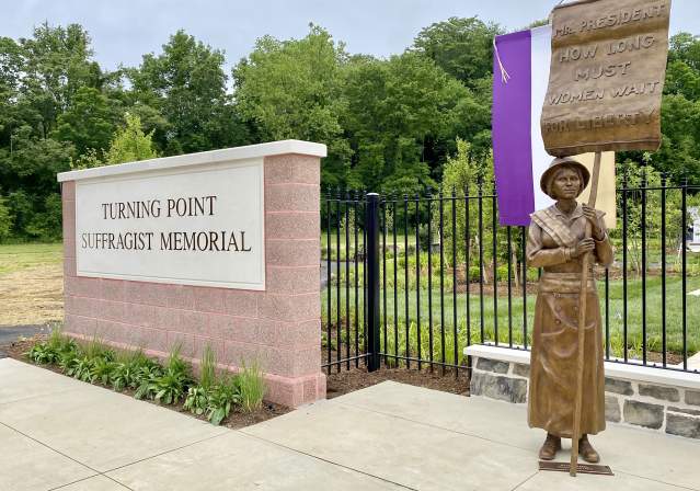 Statue of Lucy Burns to the Right of the Turning Point Suffragist Memorial Sign in Summer