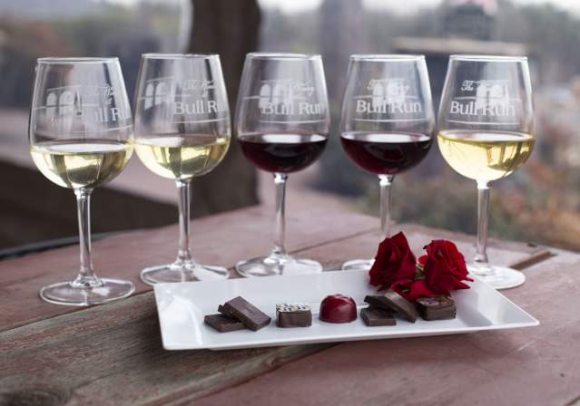 Wine glasses, chocolate, and roses in a winter setting from The Winery at Bull Run.
