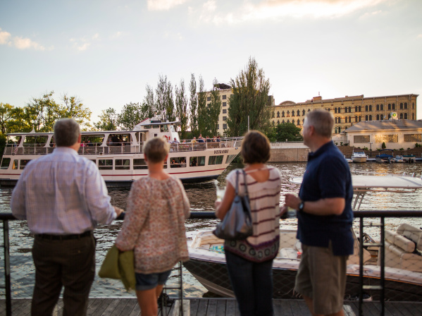 people looking at the VistaKing ship on the river in the Third Ward