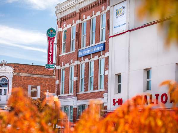 A view of downtown Bentonville, Arkansas, featuring a large brick building.