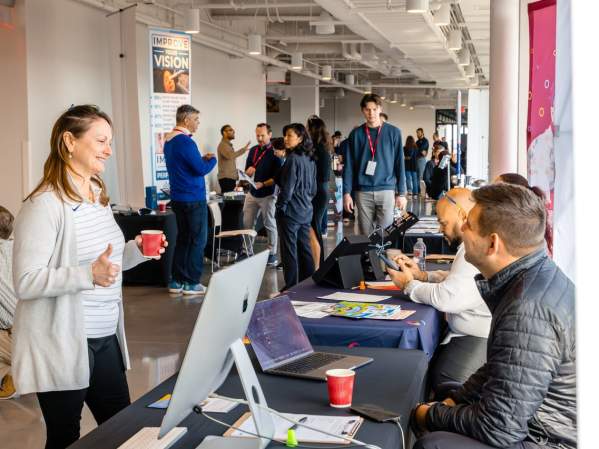 Professionals networking at a business event inside The Ledger in Bentonville, AR.