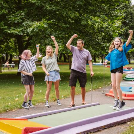 Family playing mini golf in Singleton Park