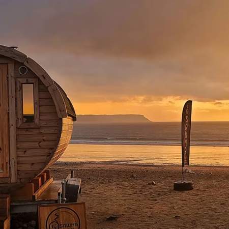 Small round wooden sauna on the beach