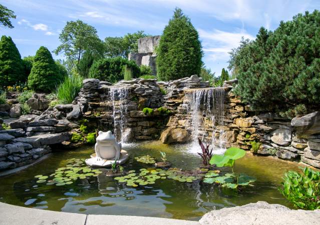 A garden pond with limestone rock and sculptures at Oliver Winery